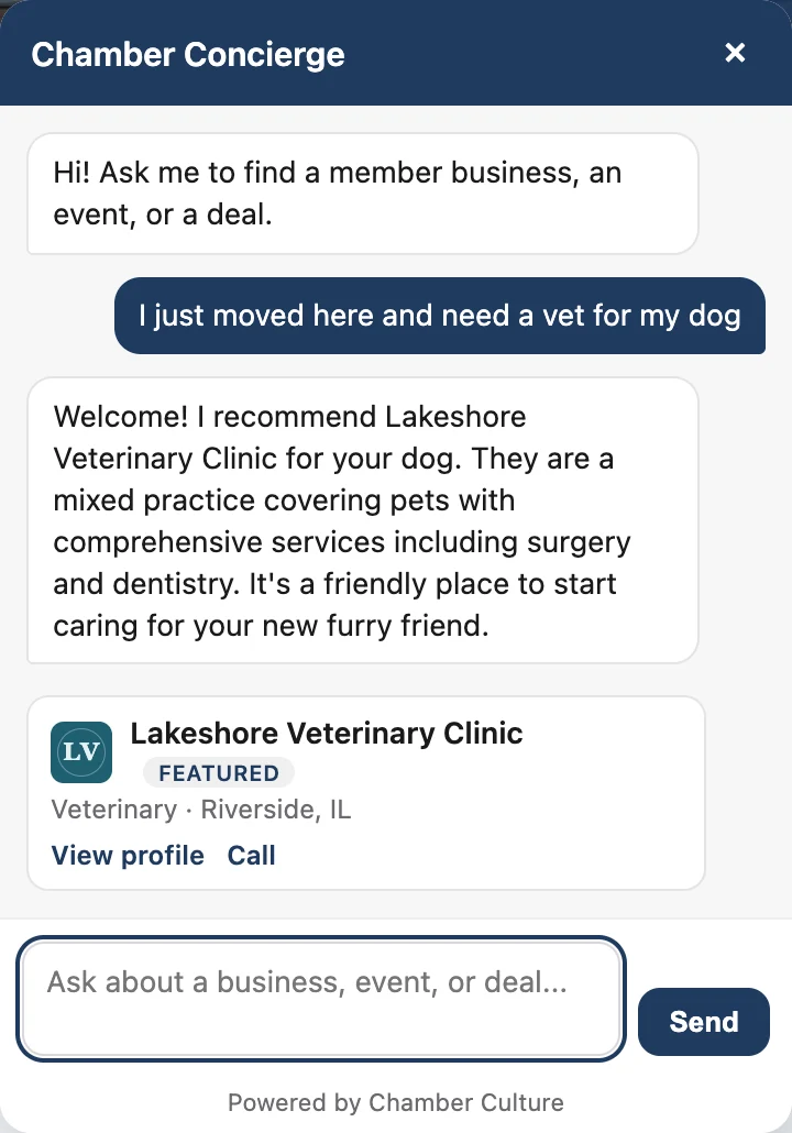 A visitor asks the chamber's AI concierge for a vet after moving to town; it recommends Lakeshore Veterinary Clinic and shows a member card with the business category, town, View profile and Call.